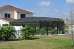 Bronze Mansard Pool Cage with 6 foot solid vinyl fence and 4 foot picket fence