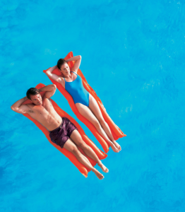 Couple floating in pool