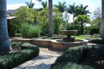 Urn fountain with pebble path and flagstone wall